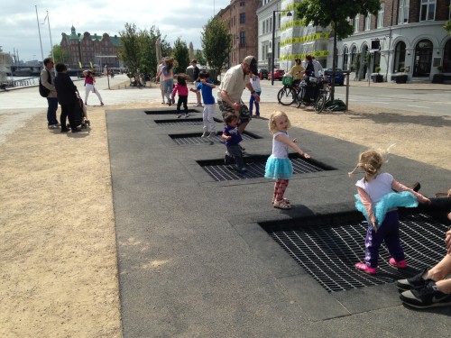 an-innovative-playground-in-copenhagen-that-has-trampolines-built-into-the-street-for-the-kids-to-jump-on
