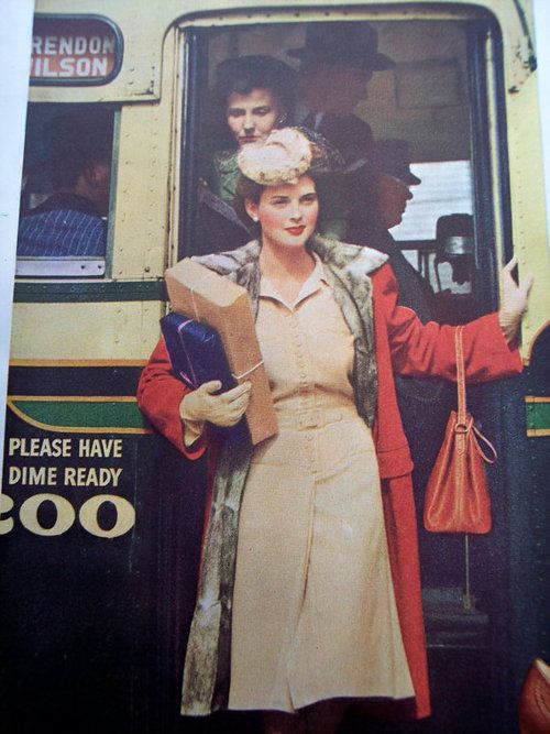 A stylishly attired woman stepping off of a bus, 1940s